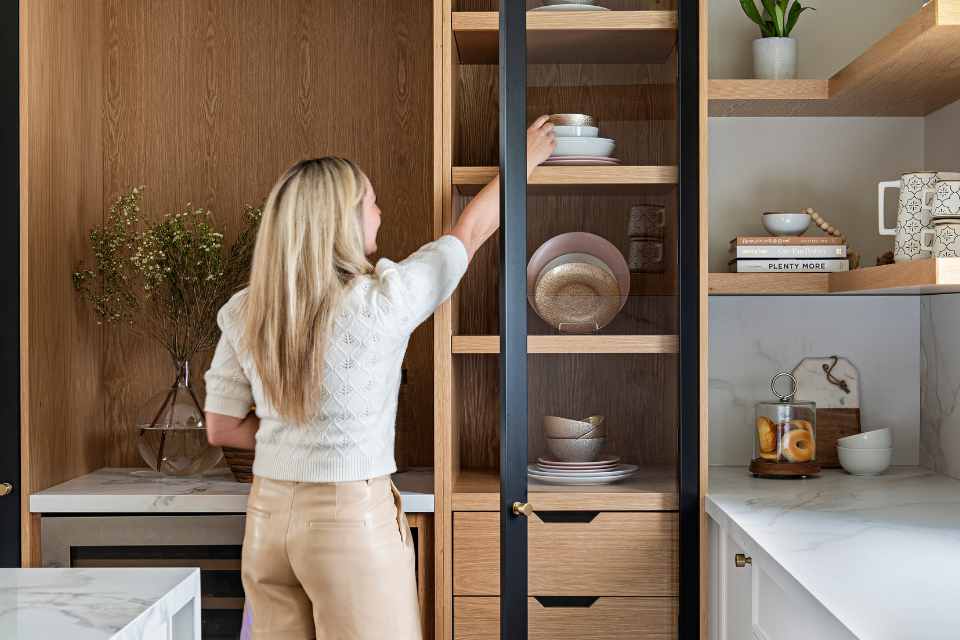 designer staging kitchen in small home with open shelving